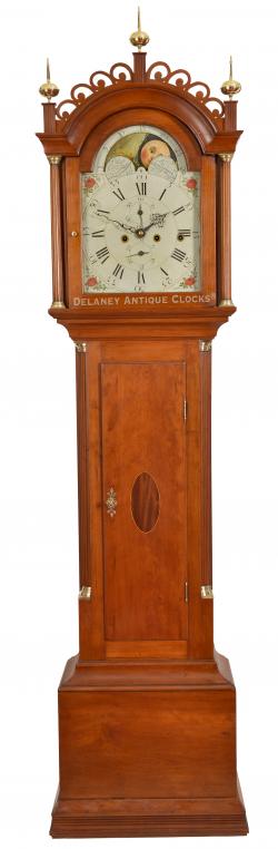 A diminutively sized inlaid cherry case tall clock made by John Fairbanks. Only 81 inches tall to the top of the center finial. It features a very unusual three-train movement designed to strike the quarter hours. 223008.