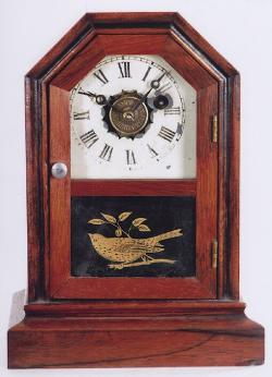 Atkins Clock Company of Bristol, Connecticut. An "Octagon Top" Cottage Clock with a time and alarm movement. TT-86.