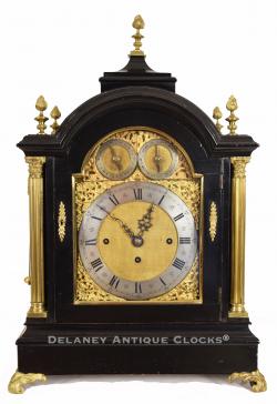 A fine English-made quarter striking Bracket clock or Table Clock. The case is finished in black lacquer and decorated with applied brass castings. The brass composite dial and three-train movement are of excellent quality. YY-69.